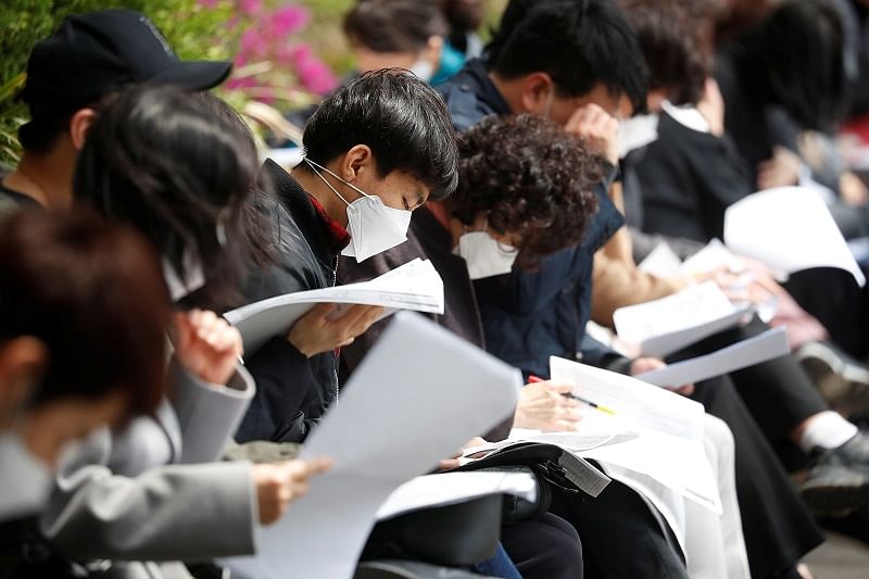 South Korean job seekers wear face masks while preparing for an exam amid social distancing measures to avoid the spread of the coronavirus disease. (Reuters Photo)