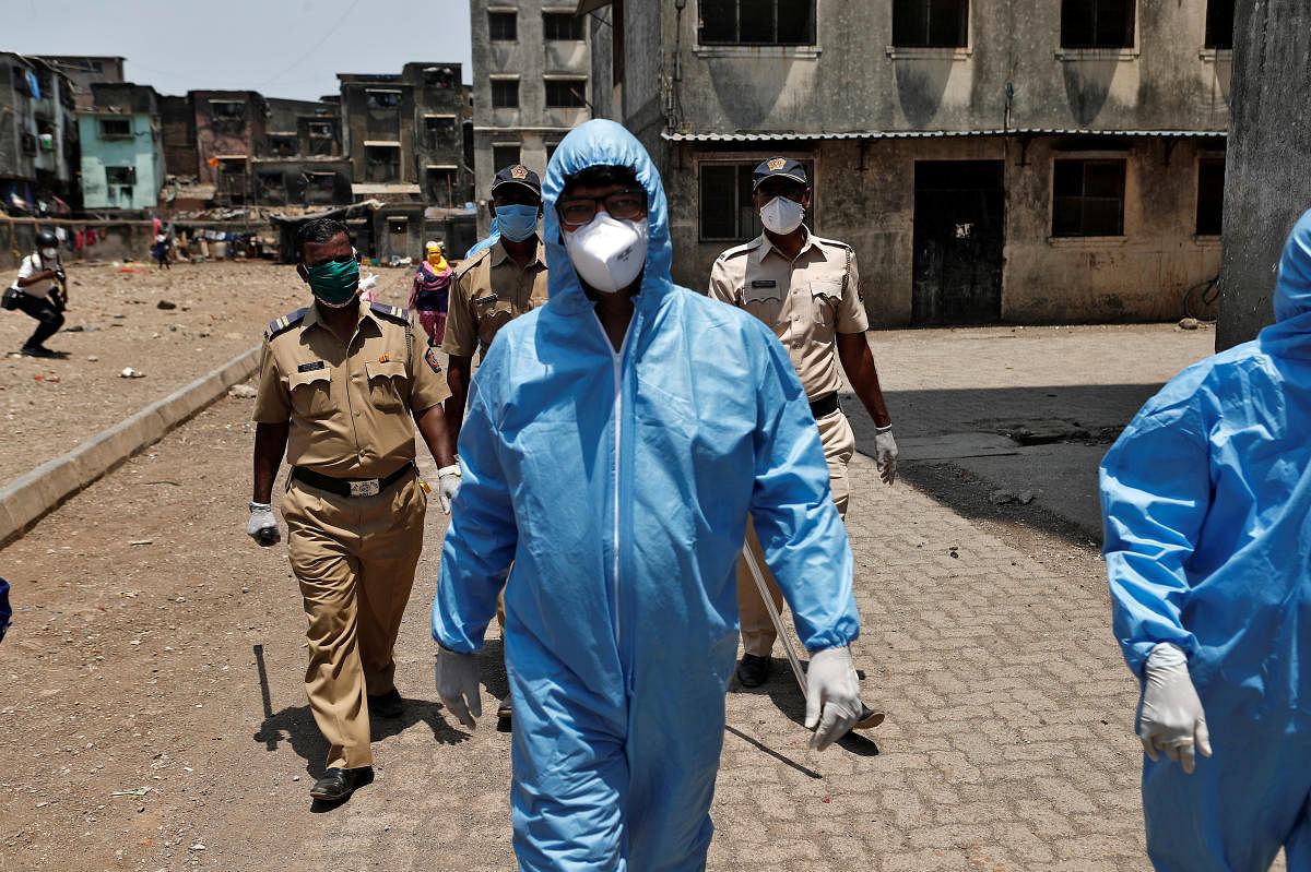Health workers wearing hazmat suits and masks are accompanied by police officers as they conduct an inspection in a residential area, during a nationwide lockdown in India to slow the spread of COVID-19, in Dharavi. (Representative Image/AFP Photo)