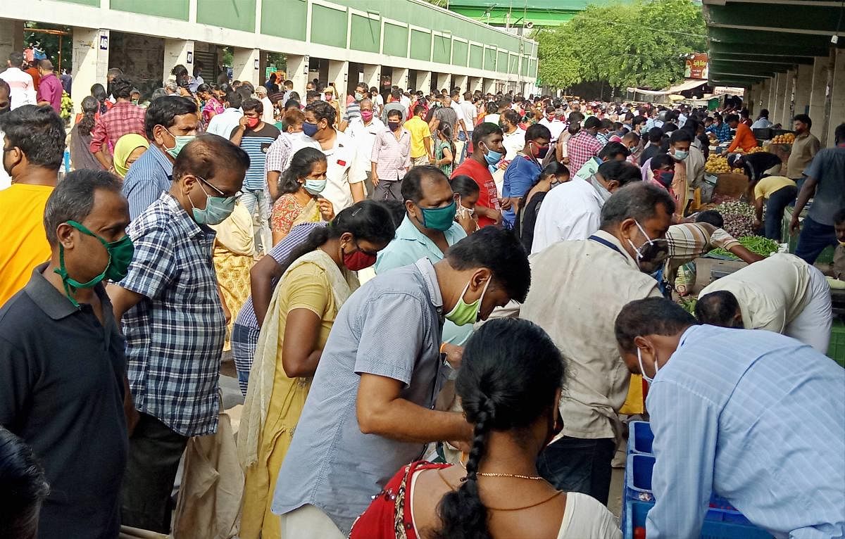 People flout lockdowm norms as they shop at a vegetable market, during the nationwide lockdown to curb the spread of coronavirus, in Coimbatore, Saturday, April 25, 2020. (PTI Photo)