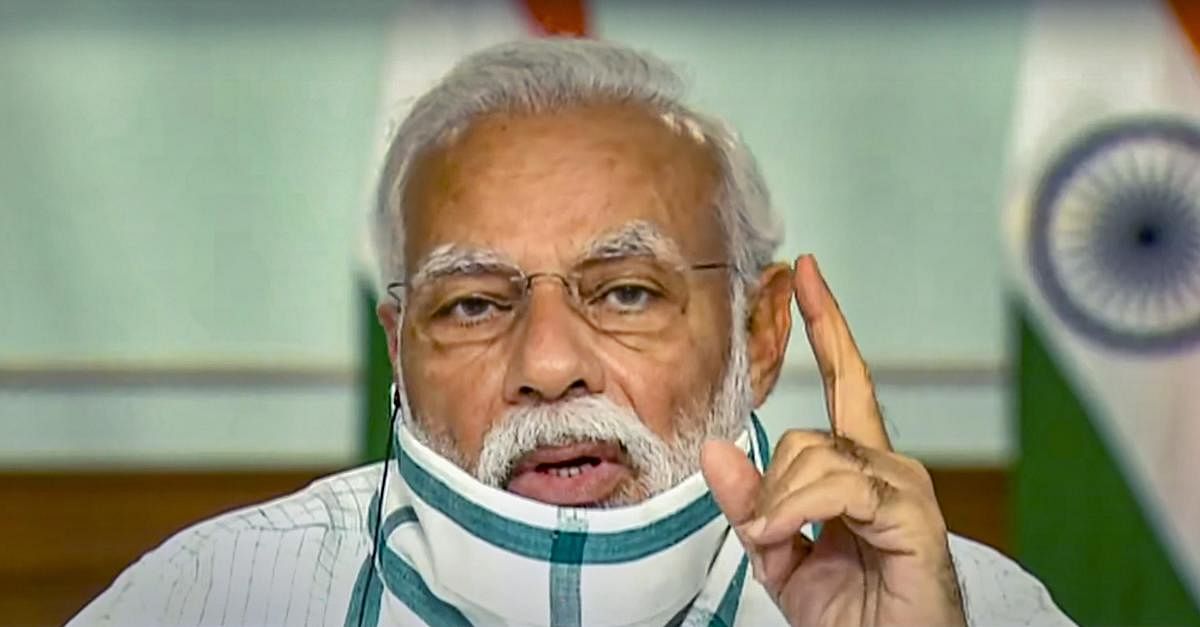 Prime Minister Narendra Modi wearing a protective mask interacts with the Chief Ministers of various States/UTs via video conferencing to discuss the situation arising due to the novel coronavirus pandemic, in New Delhi, Monday, April 27, 2020. (TV GRAB/PTI Photo)