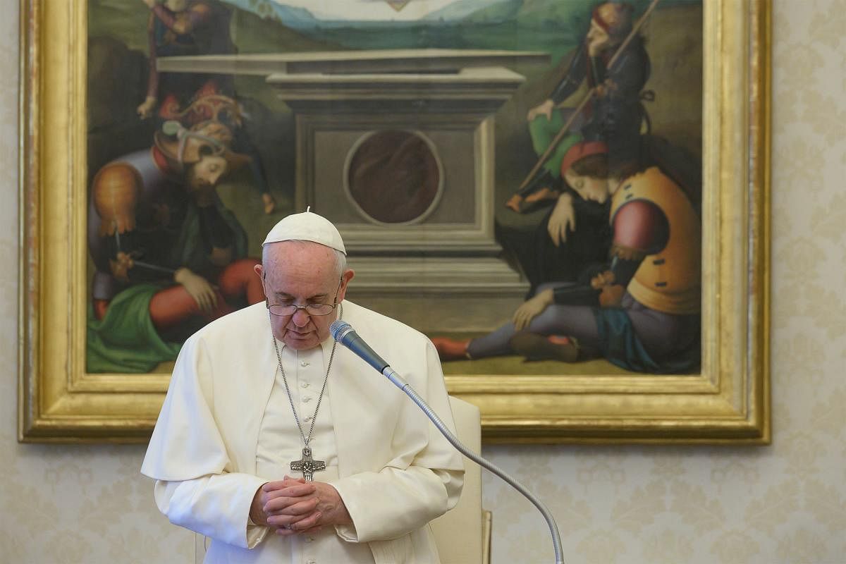 This photo taken and released on April 22, 2020 by the Vatican Media shows Pope Francis pray during a live broadcast private audience from the library of the Apostolic palace in the Vatican, during the lockdown aimed at curbing the spread of the COVID-19 infection, caused by the novel coronavirus. Credit: AFP Photo