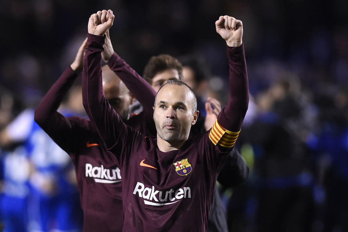 Legend: Barcelona's Andres Iniesta acknowledges the crowd after receiving a standing ovation from Deportivo Coruna fans at the Riazor stadium in Coruna on Sunday. AFP
