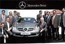 indian premier league: Mercedes-Benz Indias MD and CEO Wilfried Aulbur (right, sitting) poses with the sedan buyers  during a ceremony in Aurangabad.