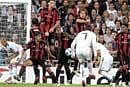 Curling It In: Real Madrid's Cristiano Ronaldo (No 7) scores from a free-kick during their Champions League match against AC Milan on Tuesday. Reuters