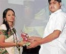 Ms Priya Gopal, wife of the late cardiac surgeon Dr Krishnagopal, receiving a bouquet from the 21-year-old youth from Pune whose life was saved by the heart transplanted from her husband, at a function in Chennai recently.