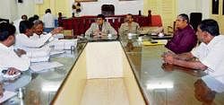 Rules for polls: Kolar DC Manoj Kumar Meena addressed party leaders at his office on Friday regarding Model Code of Conduct during polls. DSP Dr K Tyagarajan is present. DH Photo