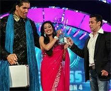 Actor and host of a TV reality show Salman Khan presents the winner's trophy to TV actress Shweta Tiwari as the first runner-up and WWE wrestler Khali looks on, during the grand finale of the show in Lonavala, Maharashtra, on Saturday night. PTI