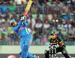 Swashbuckling innings: Virendra Sehwag hits a six as Bangladesh wicketkeeper Mushfiqur Rahim looks on during the first match in the World Cup Cricket tournament between Bangladesh and India at the Sher-e Bangla National Stadium in Dhaka on Saturday. AFP