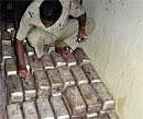 A policeman marks on the silver slabs recovered from a 200-year old mutt in Puri on Saturday.