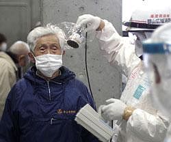 A man is scanned for radiation exposure at a temporary scanning center for residents living close to the quake-damaged Fukushima Dai-ichi nuclear power plant, on Wednesday. AP