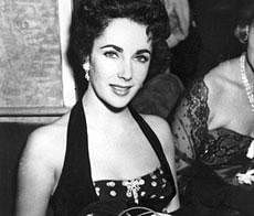 In a Sept. 22, 1951 file photo, Elizabeth Taylor is shown at the premiere of ''The Lady with the Lamp'' at the Warner Theater in London. Publicist Sally Morrison says the actress died Wednesday, March 23, 2011 in Los Angeles of congestive heart failure at age 79. AP