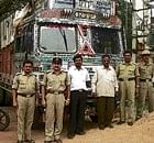 The police with the seized lorry carrying the banned African catfish in Chintamani on Monday.  DH PHOTO