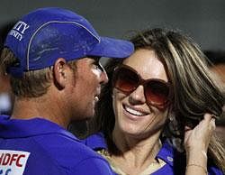 Rajasthan Royals cricket team captain Shane Warne, left, and British actor Elizabeth Hurley share a moment after an Indian Premier League (IPL) cricket match between Rajasthan Royals and Royal Challengers Bangalore in Jaipur on Wednesday. AP