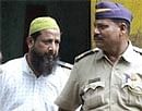 Hanif Sayyed, accused in 2003 twin blasts case on his way to a special POTA court in Mumbai on Monday.PTI