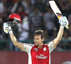 Kings XI Punjab Adam Gilchrist celebrates his century against Royal Challengers Bangalore during their IPL-4 match in Dharamsala on Tuesday. PTI Photo