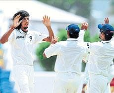 On a roll: Ishant Sharma celebrates with his team-mates after winkling out Ramnaresh Sarwan on the second day of the second Test on Wednesday. AFP