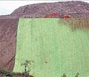 Cover-Up Act: A huge polythene sheet drapes a hillside ravaged by mining at Megalahalli in Chitradurga district on Saturday. DH Photo