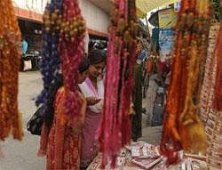 Shoppers look at Rakhi bracelets in a shop ahead of Raksha Bandhan festival in Siliguri on August 11, 2011. AFP
