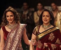 Bollywood actress Hema Malini, right, and her daughter Esha Deol display creations by designers Shyamal and Bhumika during Lakme Fashion Week in Mumbai, India, Friday, Aug. 19, 2011. AP Photo
