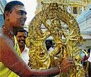 A priest cleans the idol of Goddess Chamundeshwari at the temple atop Chamundi hill in Mysore on Tuesday.  Dh photo