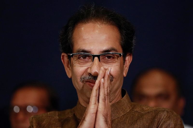 Shiv Sena chief Uddhav Thackeray greets people after arriving at a press conference with Nationalist Congress Party president Sharad Pawar in Mumbai, India. (Reuters Photo)