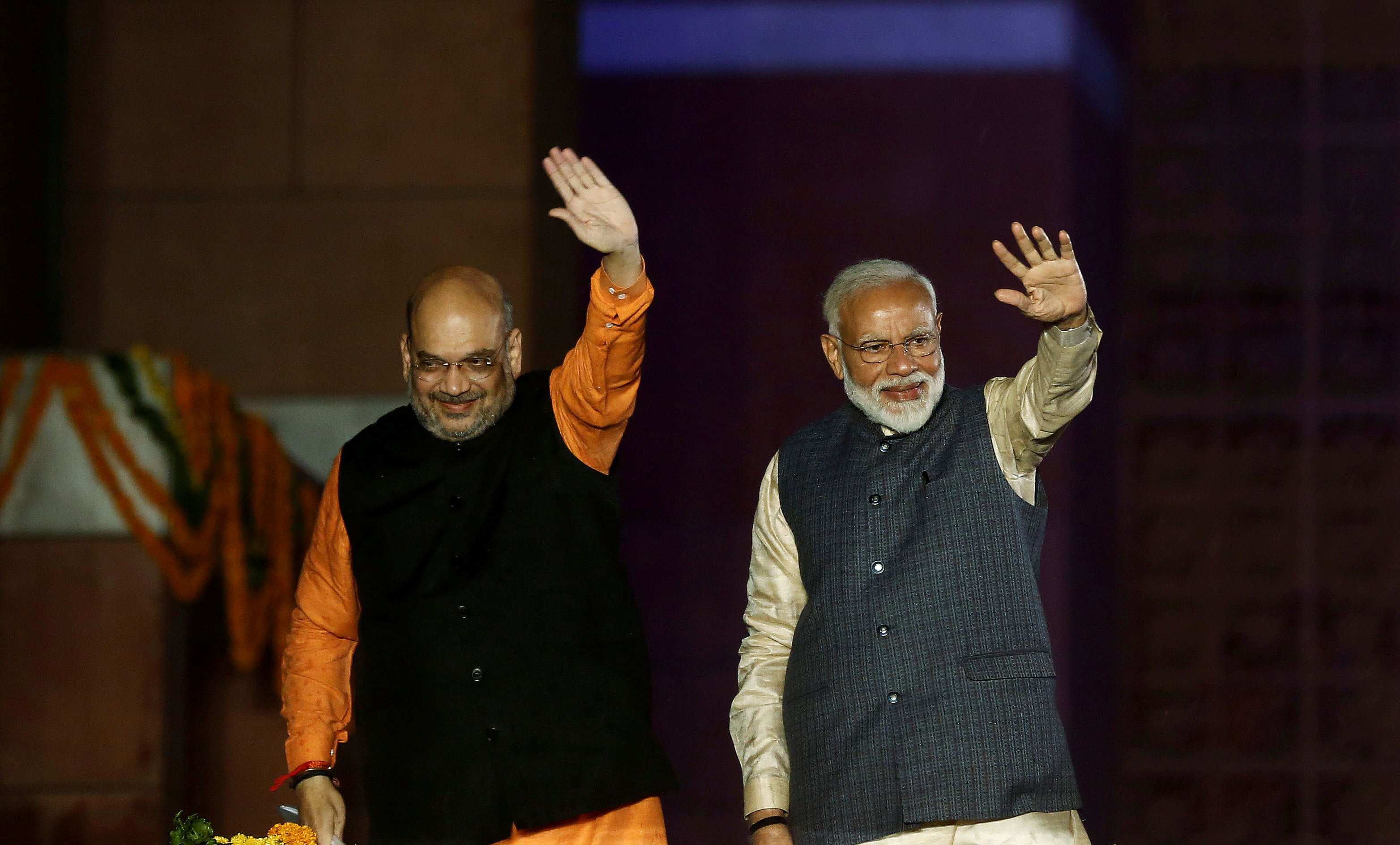 Indian Prime Minister Narendra Modi and Bharatiya Janata Party (BJP) President Amit Shah wave towards their supporters after the election results at party headquarter in New Delhi. (Reuters Photo)
