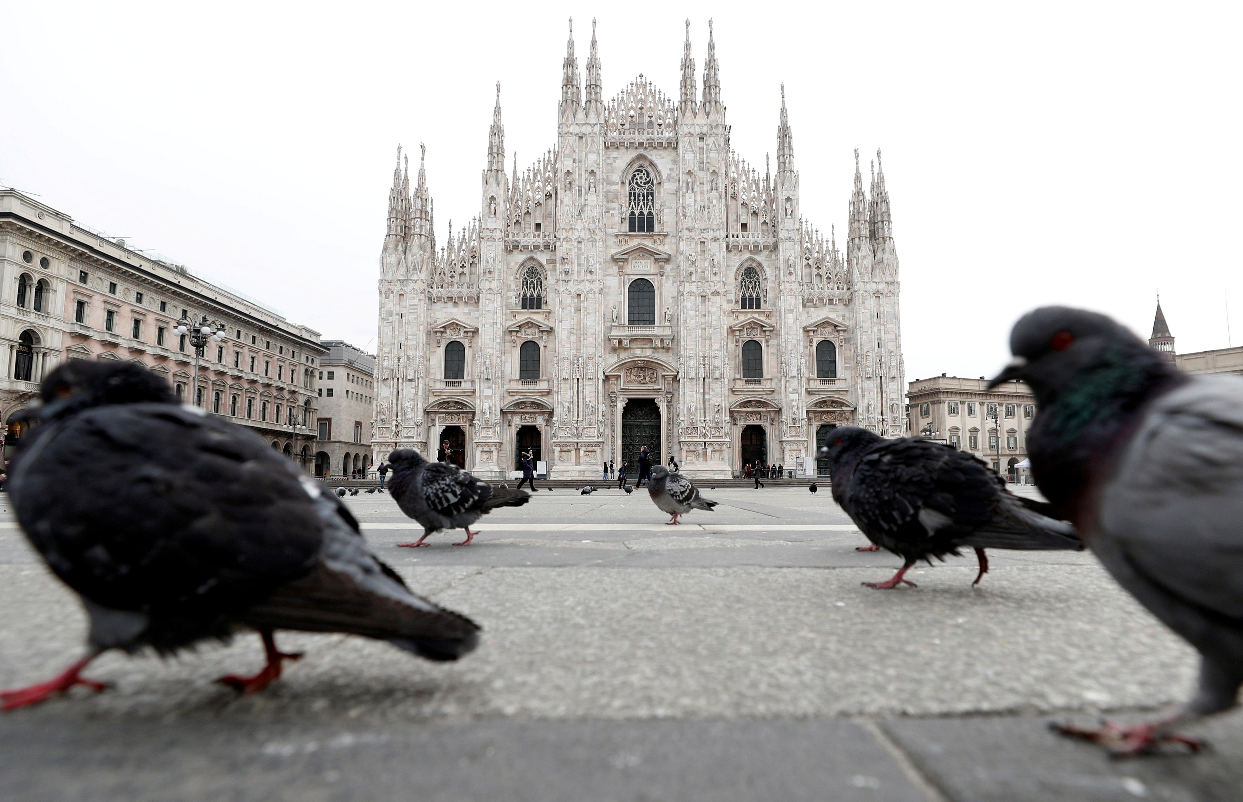 Pigeons roam around Piazza Duomo square after a lockdown is imposed in Northern Italy. (Credit: Reuters)