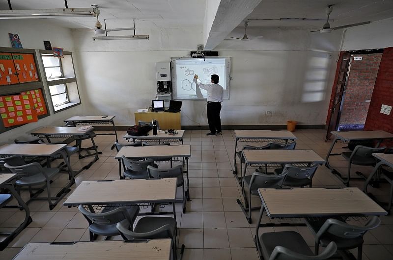 A teacher takes an online class for his students inside a private school after Gujarat government ordered the closure of schools and colleges across the state amid coronavirus fears. (Reuters Photo)