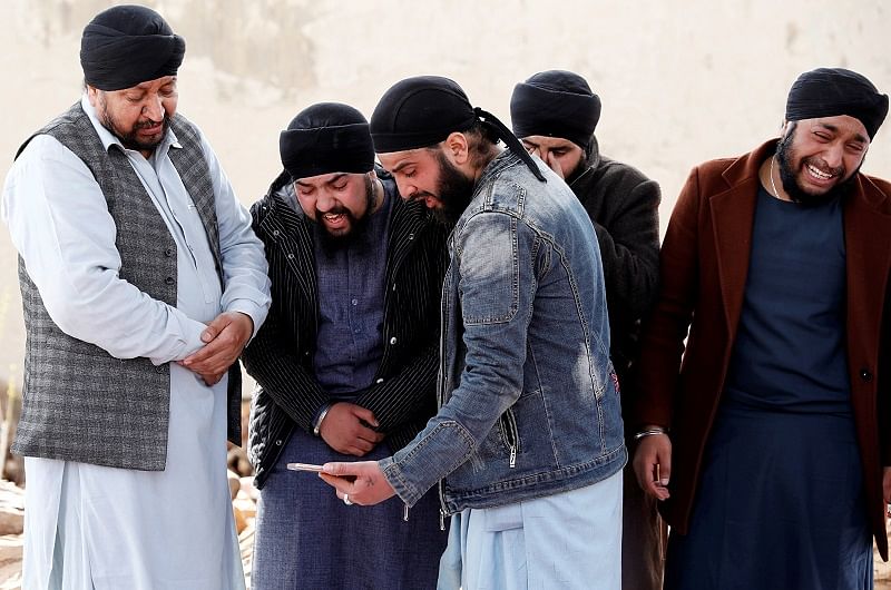 Afghan Sikh men mourn during funeral for the victims who were killed during yesterday's attack at Sikh religious complex during a funeral in Kabul, Afghanistan. (Reuters Photo)