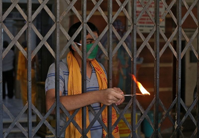 A Hindu priest performs a ritual known as Aarti to bless the devotees (not pictured) on the occasion of Ramnavmi festival at a temple during a 21-day nationwide lockdown. (Reuters Photo)