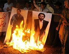 Angry Pakistani cricket fans burn posters of disgraced Pakistani crickets Salam Butt, left, and Mohammad Asif in Multan, Pakistan. AP Photo