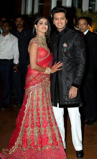 Ritesh Deshmukh and Genelia D'Souza who married yesterday pose during reception in Mumbai on Saturday. PTI Photo