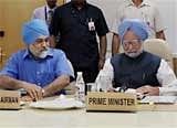 Prime Minister and Chairman of Planning Commission Manmohan Singh (R) and Deputy Chairman Montek Singh at the full Planning Commission meeting