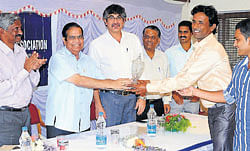 KSCA Mangalore Zone Chairman P Dayanand Pai hands over the First Division Cricket                 Championship-2011winners trophy to City Cricketers Captain Vishwanath Puthran. KSCA Mangalore Zone Convener Dr Srikanth Rai, KSCA Co-ordinator A V Sashidar among others    look on.