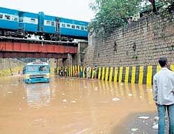 Messy situation: A BMTC bus stuck in rain water under the bridge near Kino Theatre in  Bangalore on Friday. DH photo