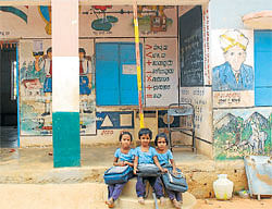 No hope: Students pose in front of the Government primary school at Tandramaradahalli, which will soon be shut down. (R) A classroom at the school. DH Photos