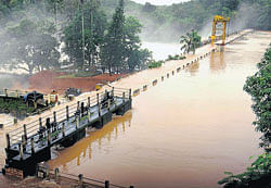 Pazhassi Dam is seen overflowing due to heavy rain in Kannur district on Tuesday. PTI