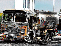 Charred remains of a tanker in Mayur Vihar. A mob had gone on a rampage and clashed with police on Sunday night. PTI