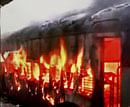 Hyderabad-Solapur Falaknuma express catches fire at the Gulbarga railway station in Karnataka on Tuesday. PTI /TV Grab