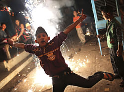 An Indian Sikh boy leaps out of the way of a firecracker as he and friends celebrate the festival of Diwali in New Delhi, India, Tuesday, Nov. 13, 2012. Diwali, the festival of lights dedicated to the Goddess of wealth Lakshmi, is being celebrated across the country Tuesday. AP