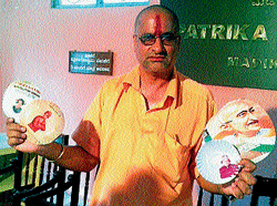 Zilla panchayat member Ballaranda Mani Uthappa exhibits paper plates with photographs of national leaders. DH Photo