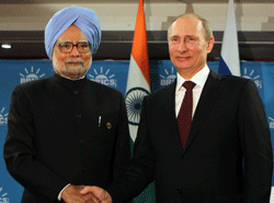 Prime Minsiter Manmohan Singh shakes hands with Russian President V Putin during a bilateral meeting ahead of the BRICS 5 Summit in Durban, South Africa on Tuesday. PTI Photo