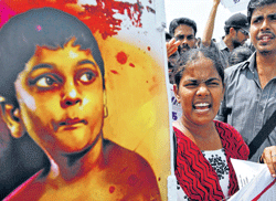 College students protest in Chennai, next to a portrait of Balachandran, 12-year-old son of Sri Lankan Tamil Tiger leader V Prabhakaran, in the wake of allegations that he was killed in war crimes by the island government during the final months of a three-decade war with ethnic tamil rebels in 2009.