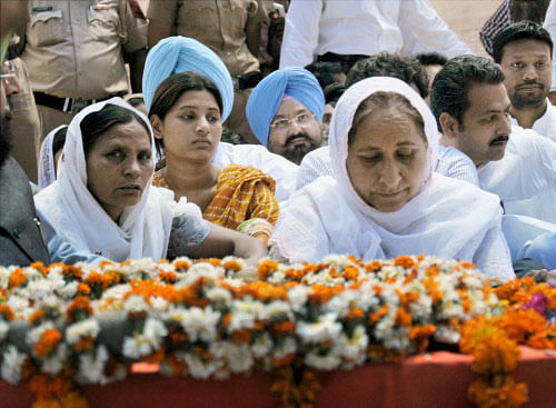 Family members of Sarabjit Singh during his funeral procession at his native village Bhikhiwind near Amritsar on Friday. Indian prisoner Sarabjit Singh died after being brutally assaulted in a Pakistani jail. PTI Photo by Deepak Sharma