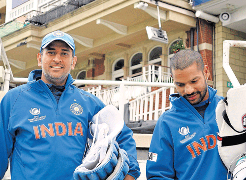M S Dhoni with S Dhavan during a practice session on the eve of their ICC Champions Trophy cricket match against Pakistan in Oval, London on Monday. PTI Photo