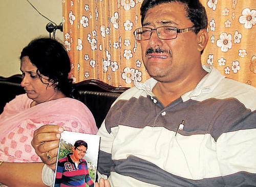 Sandeep Salwan and his wife with their son's photo.