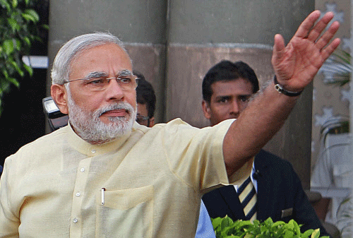 Gujarat Chief Minister Narendra Modi waves to crowd after his meeting with the businessmen in Mumbai on Thursday PTI Photo