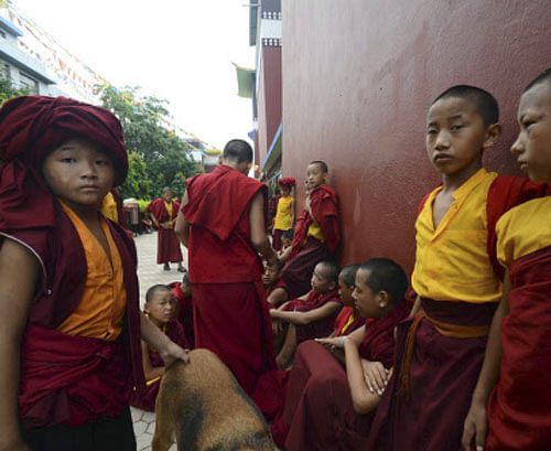 Novice Buddhist monks wait outside the Tergar Monastery, the site of an explosion, in Bodhgaya, about 130 kilometers (80 miles) south of Patna, the capital of the eastern Indian state of Bihar, Sunday, July 7, 2013. A series of small blasts hit three Buddhist temples in eastern India early Sunday, injuring at least two people, police said. AP Photo