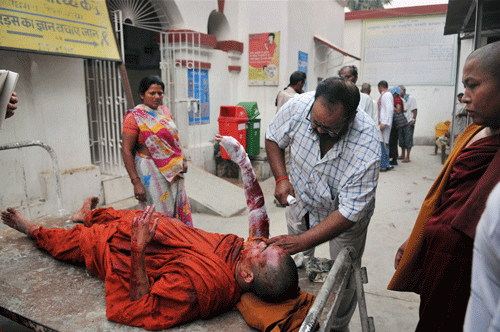 : A Buddhist monk being treated after he was injured in an explosion in Mahabodhi Temple campus at Bodhgaya on Sunday. Nine serial explosions today rocked the internationally renowned temple town of Bodh Gaya. PTI Photo(