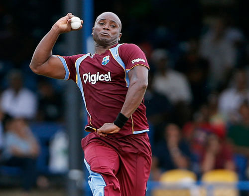 West Indies' Tino Best bowls during the Tri-Nation Series cricket match against India in Port-of-Spain, Trinidad, Friday, July 5, 2013. (AP Photo